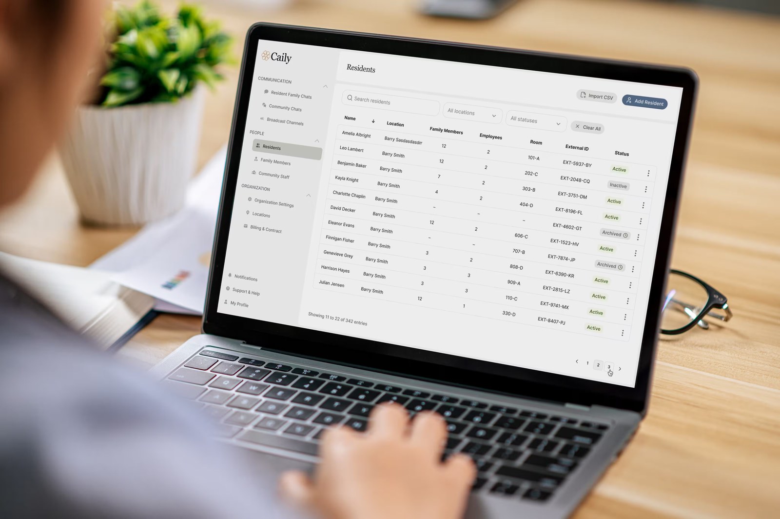 A senior-living manager at a desk with the Caily web app